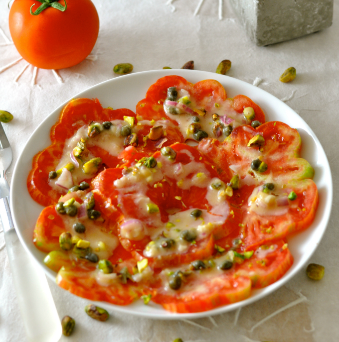 A summer salad you will never forget. Heirloom tomatoes topped with an oil-free pistachio vinaigrette. (#vegan) ordinaryvegan.net